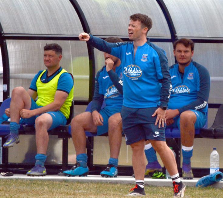 Hakin manager Scott Davies gives instructions to his team